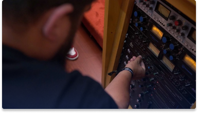 man adjusting sound equipment